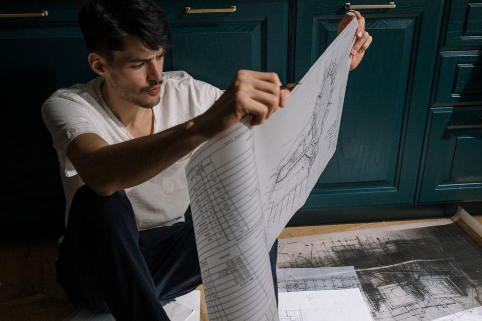 Kitchen design blueprints and layout sketches on a desk